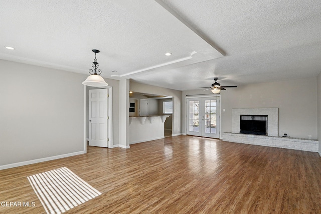10224 Galahad Way, El Paso, TX 79924 - unfurnished living room with a textured ceiling, baseboards, wood finished floors, ceiling fan, and recessed lighting