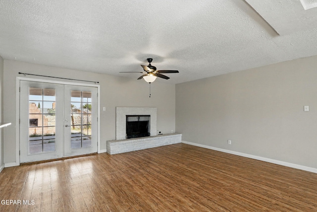10224 Galahad Way, El Paso, TX 79924 - unfurnished living room featuring wood finished floors, baseboards, french doors, a ceiling fan, and a textured ceiling