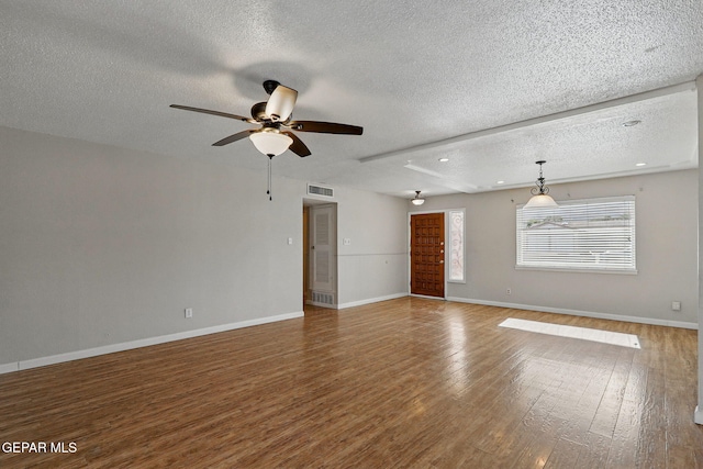 10224 Galahad Way, El Paso, TX 79924 - unfurnished living room with a textured ceiling, wood finished floors, ceiling fan, and baseboards