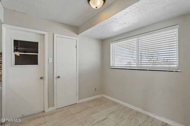 10224 Galahad Way, El Paso, TX 79924 - spare room featuring a textured ceiling, baseboards, and ceiling fan