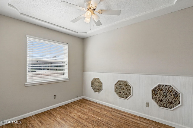 10224 Galahad Way, El Paso, TX 79924 - spare room featuring wood finished floors, baseboards, a textured ceiling, and ceiling fan