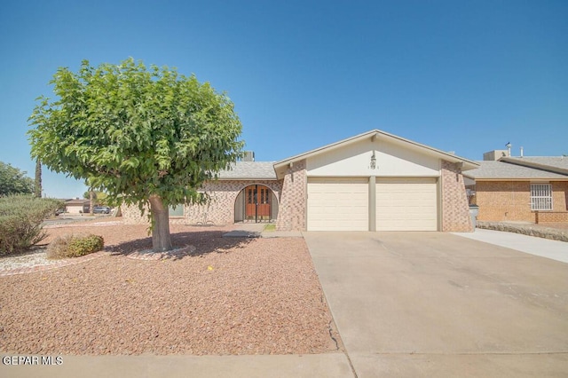 1701 Paul Moran Pl, El Paso, TX 79936 - ranch-style house featuring a garage, concrete driveway, and brick siding