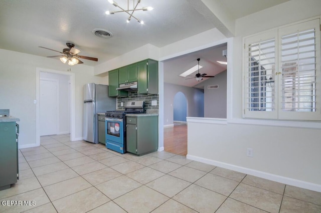 1701 Paul Moran Pl, El Paso, TX 79936 - kitchen with appliances with stainless steel finishes, green cabinets, ceiling fan, under cabinet range hood, and light tile patterned flooring