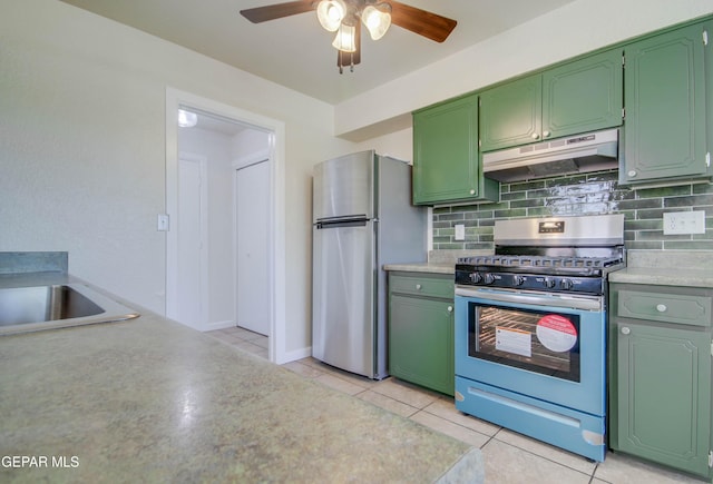 1701 Paul Moran Pl, El Paso, TX 79936 - kitchen featuring appliances with stainless steel finishes, under cabinet range hood, green cabinetry, a ceiling fan, and tasteful backsplash