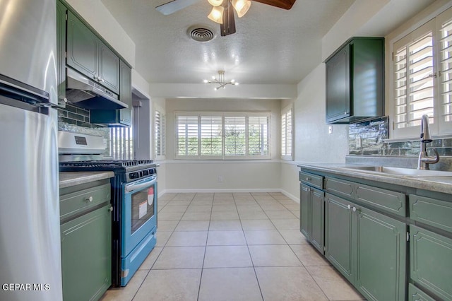 1701 Paul Moran Pl, El Paso, TX 79936 - kitchen with appliances with stainless steel finishes, green cabinets, a sink, under cabinet range hood, and a textured ceiling
