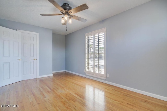 1701 Paul Moran Pl, El Paso, TX 79936 - unfurnished bedroom with light wood-type flooring, baseboards, and a ceiling fan