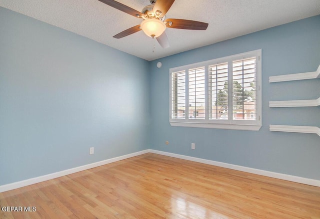 1701 Paul Moran Pl, El Paso, TX 79936 - spare room with wood finished floors, ceiling fan, a textured ceiling, and baseboards