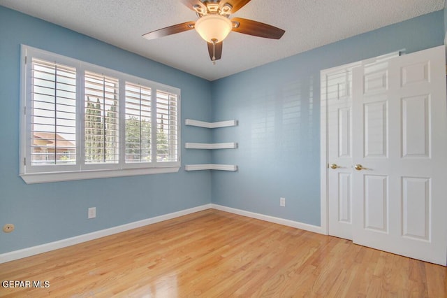 1701 Paul Moran Pl, El Paso, TX 79936 - unfurnished room with wood finished floors, a textured ceiling, baseboards, and ceiling fan