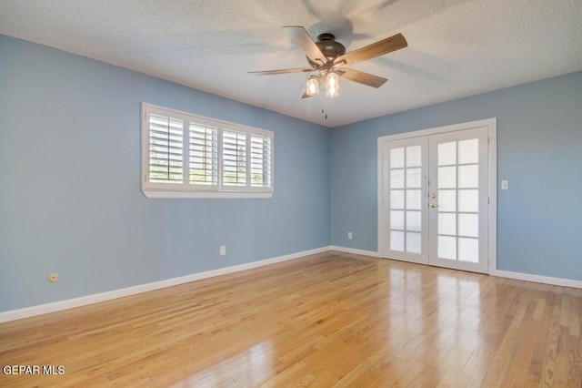 1701 Paul Moran Pl, El Paso, TX 79936 - spare room featuring french doors, wood finished floors, a ceiling fan, a textured ceiling, and baseboards