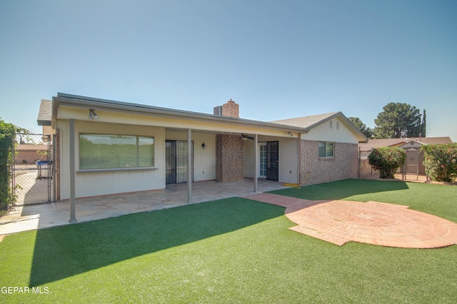 1701 Paul Moran Pl, El Paso, TX 79936 - rear view of property featuring a chimney, a ceiling fan, a patio, and a gate