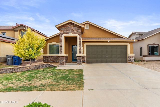14196 Greg Allen, El Paso, TX 79938 - view of front of house featuring stucco siding, stone siding, an attached garage, and driveway