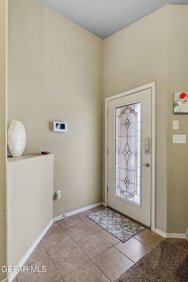 14196 Greg Allen, El Paso, TX 79938 - laundry area featuring hookup for a washing machine, light tile patterned floors, and baseboards