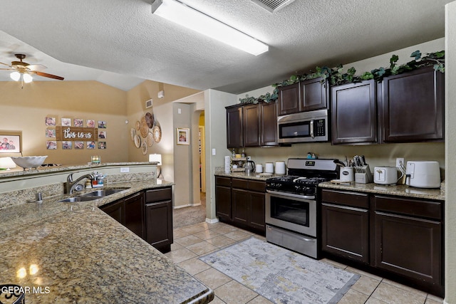 14196 Greg Allen, El Paso, TX 79938 - kitchen featuring stainless steel appliances, a sink, a ceiling fan, light tile patterned floors, and dark brown cabinets