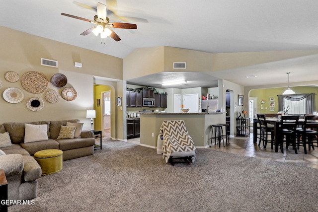 14196 Greg Allen, El Paso, TX 79938 - living area featuring arched walkways, a ceiling fan, light carpet, lofted ceiling, and light tile patterned floors