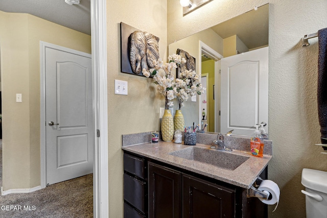 14196 Greg Allen, El Paso, TX 79938 - bathroom featuring vanity, toilet, and a textured wall
