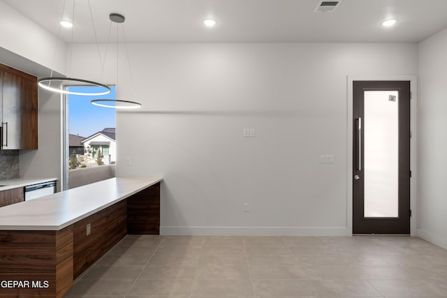 832 Acton St, Horizon City, TX 79928 - kitchen featuring light countertops, white dishwasher, a peninsula, baseboards, and decorative light fixtures