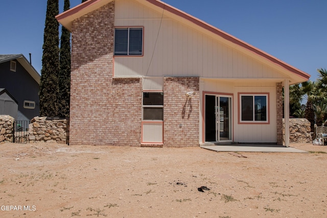 11896 Crimson Sky Dr, El Paso, TX 79936 - rear view of house with brick siding and a patio area