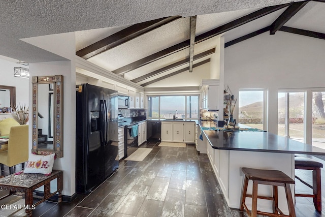 3104 Pagosa Ct, El Paso, TX 79904 - kitchen with black appliances, a sink, a peninsula, white cabinets, and dark countertops