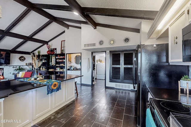 3104 Pagosa Ct, El Paso, TX 79904 - kitchen featuring dark countertops, white cabinetry, beamed ceiling, decorative backsplash, and electric range
