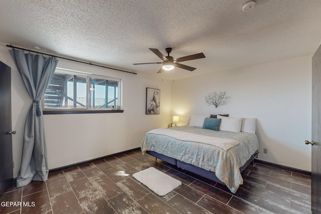 3104 Pagosa Ct, El Paso, TX 79904 - bedroom featuring a textured ceiling, baseboards, and a ceiling fan