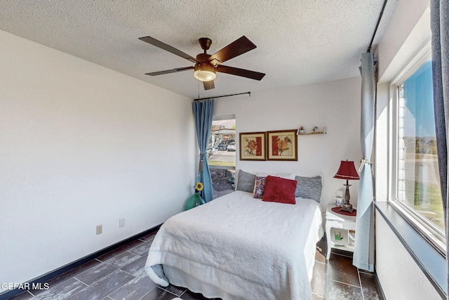 3104 Pagosa Ct, El Paso, TX 79904 - bedroom with multiple windows, a textured ceiling, and ceiling fan