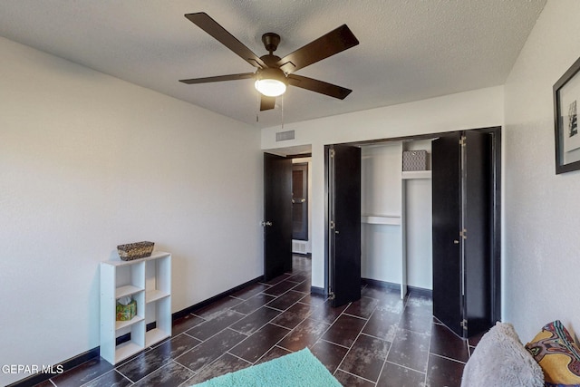 3104 Pagosa Ct, El Paso, TX 79904 - bedroom with a textured ceiling, baseboards, ceiling fan, and a closet