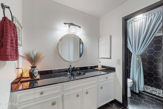3104 Pagosa Ct, El Paso, TX 79904 - bathroom with vanity, toilet, tiled shower, and tile patterned floors