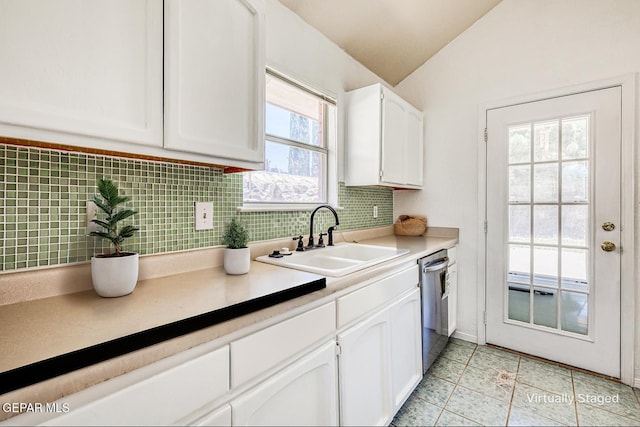 12044 Banner Crest Dr, El Paso, TX 79936 - kitchen featuring a sink, dishwasher, white cabinets, backsplash, and lofted ceiling