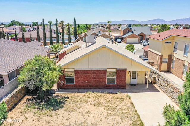 12044 Banner Crest Dr, El Paso, TX 79936 - view of front of property with a residential view, brick siding, and a mountain view