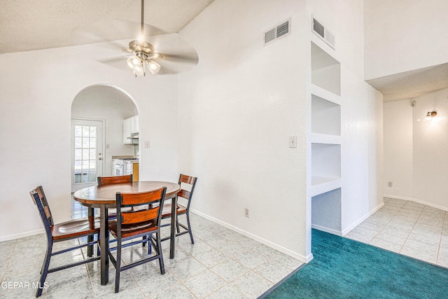 12044 Banner Crest Dr, El Paso, TX 79936 - dining room with arched walkways, ceiling fan, built in shelves, and baseboards