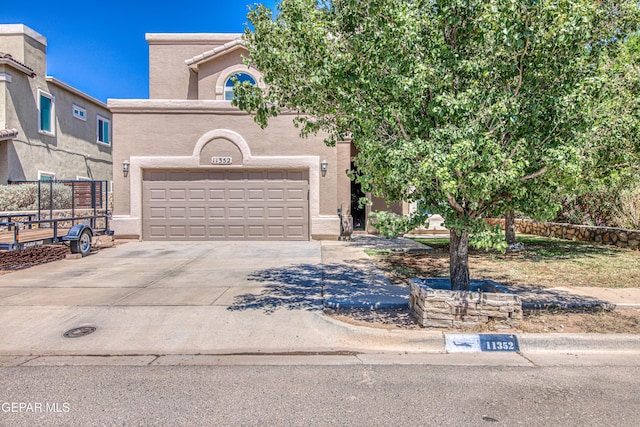 11352 Bullseye St, El Paso, TX 79934 - view of front facade with driveway, stucco siding, and a garage
