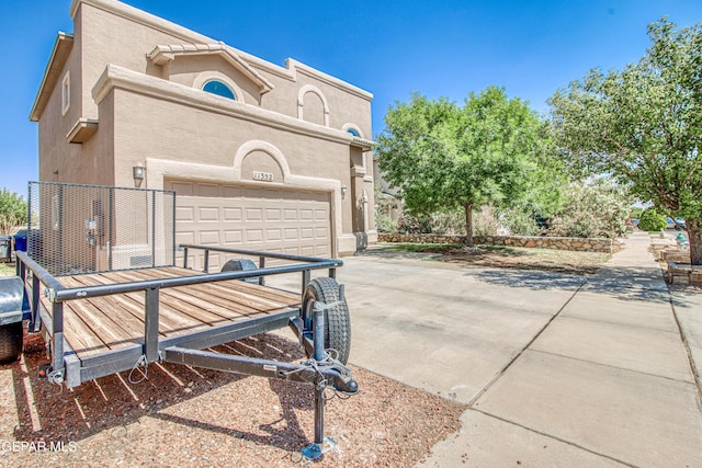 11352 Bullseye St, El Paso, TX 79934 - view of side of property featuring driveway, stucco siding, and an attached garage