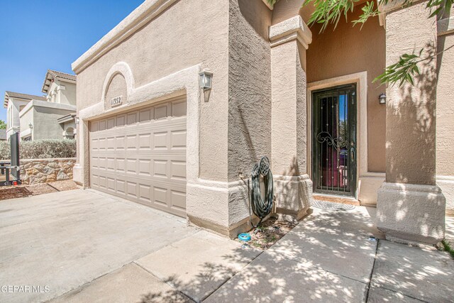 11352 Bullseye St, El Paso, TX 79934 - doorway to property featuring stucco siding and concrete driveway