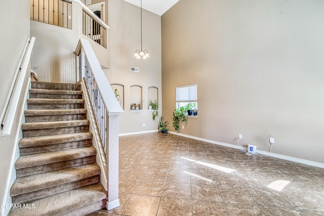 11352 Bullseye St, El Paso, TX 79934 - stairway with a high ceiling, a chandelier, and baseboards