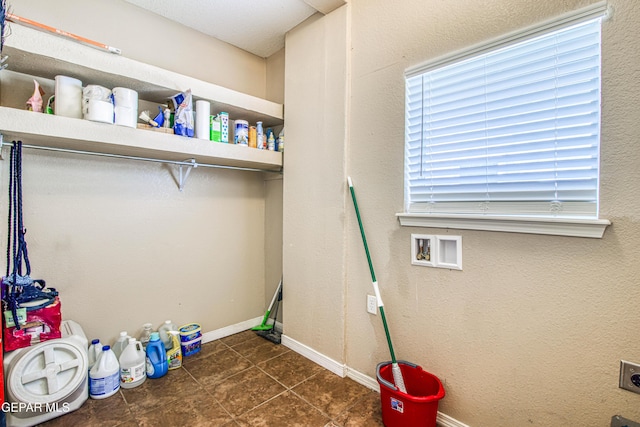 11352 Bullseye St, El Paso, TX 79934 - laundry area with tile patterned flooring, electric dryer hookup, hookup for a washing machine, and baseboards