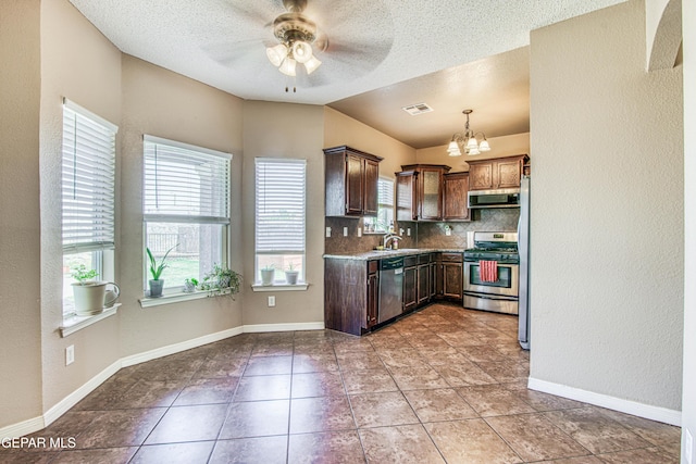 11352 Bullseye St, El Paso, TX 79934 - kitchen featuring stainless steel appliances, extractor fan, a sink, a ceiling fan, and a chandelier