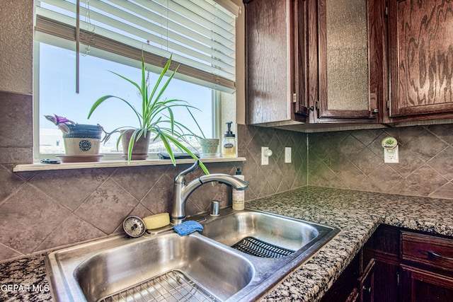 11352 Bullseye St, El Paso, TX 79934 - kitchen featuring a sink, decorative backsplash, and dark brown cabinets