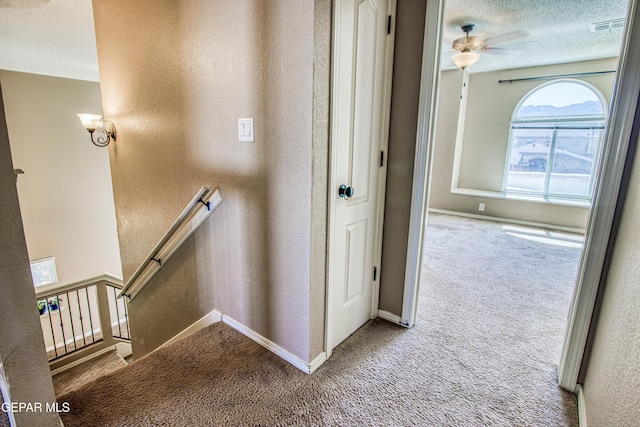 11352 Bullseye St, El Paso, TX 79934 - stairway with carpet, a textured wall, a ceiling fan, baseboards, and a textured ceiling