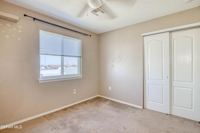 11352 Bullseye St, El Paso, TX 79934 - unfurnished bedroom featuring light colored carpet, a closet, a textured ceiling, baseboards, and a ceiling fan