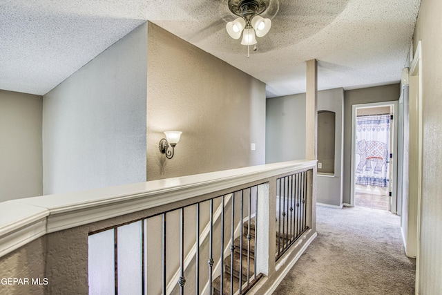 11352 Bullseye St, El Paso, TX 79934 - hallway with a textured wall, a textured ceiling, and carpet floors