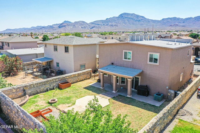 11352 Bullseye St, El Paso, TX 79934 - back of house featuring a mountain view, a patio area, a residential view, stucco siding, and cooling unit