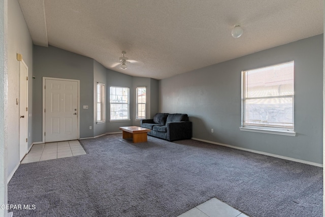 6224 Rhine Bridge Dr, El Paso, TX 79934 - unfurnished room featuring carpet floors, a textured ceiling, tile patterned flooring, lofted ceiling, and a ceiling fan