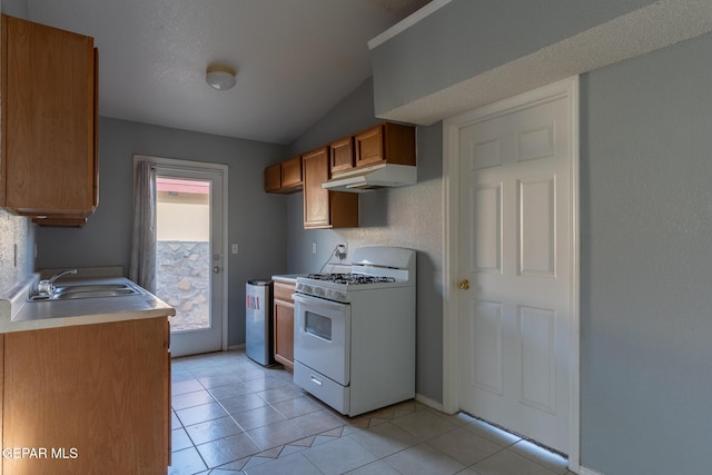 6224 Rhine Bridge Dr, El Paso, TX 79934 - kitchen featuring gas range gas stove, under cabinet range hood, brown cabinets, lofted ceiling, and light countertops