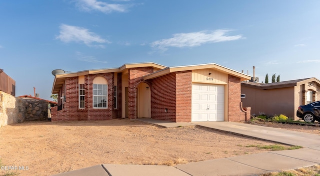 6224 Rhine Bridge Dr, El Paso, TX 79934 - ranch-style house featuring a garage, brick siding, and concrete driveway