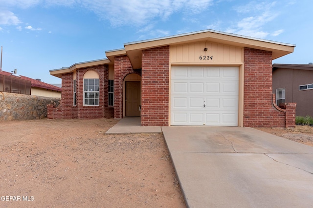 6224 Rhine Bridge Dr, El Paso, TX 79934 - view of front of house featuring an attached garage, brick siding, and driveway