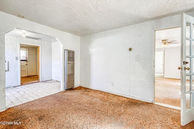 124 N Toledo Pl, El Paso, TX 79905 - spare room featuring a heating unit, a textured wall, and a textured ceiling