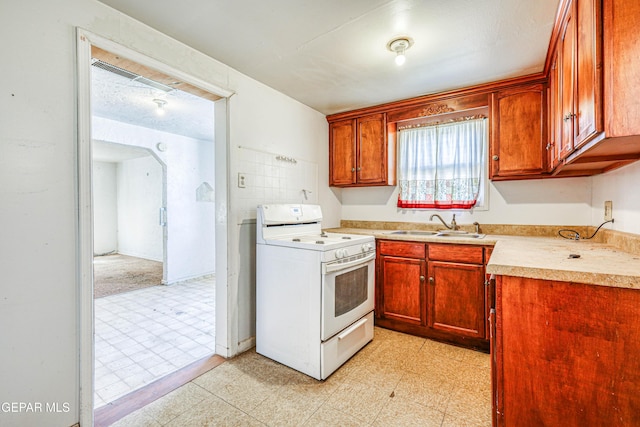 124 N Toledo Pl, El Paso, TX 79905 - kitchen featuring electric range, light countertops, a sink, and light flooring