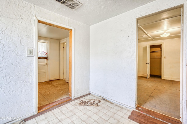 124 N Toledo Pl, El Paso, TX 79905 - spare room featuring a textured wall and baseboards