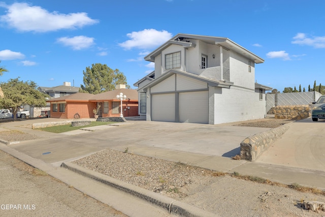 12055 Van Gogh Dr, El Paso, TX 79936 - view of front of home with brick siding, an attached garage, and concrete driveway