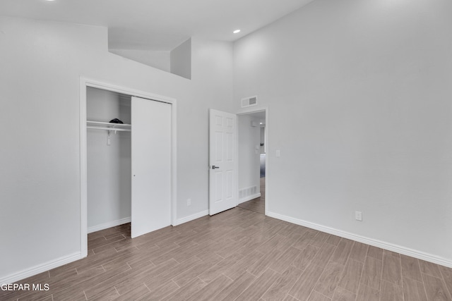 12055 Van Gogh Dr, El Paso, TX 79936 - unfurnished bedroom with baseboards, wood finished floors, a closet, recessed lighting, and a high ceiling